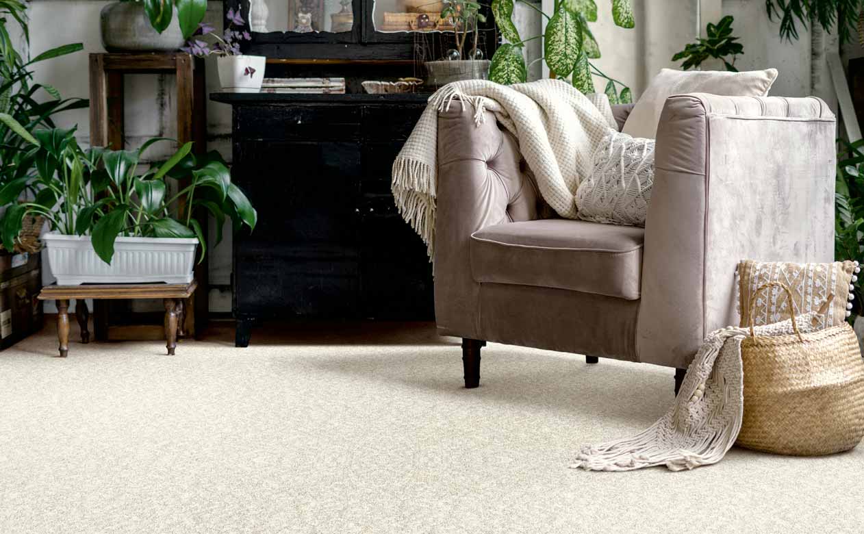Living room with brown chair and dresser with beige carpet